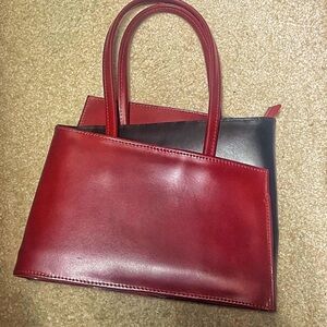 Chic Red and Black Shoulder Bag with High-Quality Leather and Structured Shape